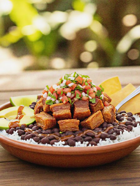 bowl of chifrijo with Rice, beans, pork, avocado, salsa